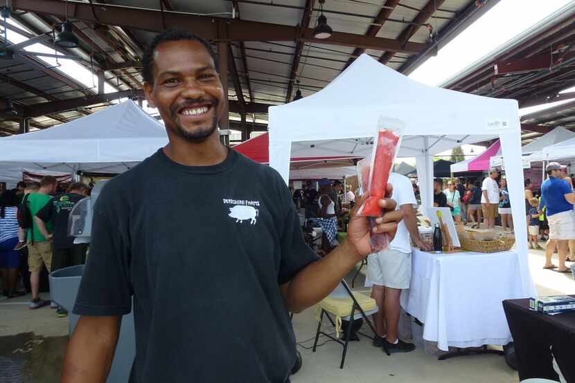 Jason Jackson holds up the frozen wine pops that his family brings to area farmers market...