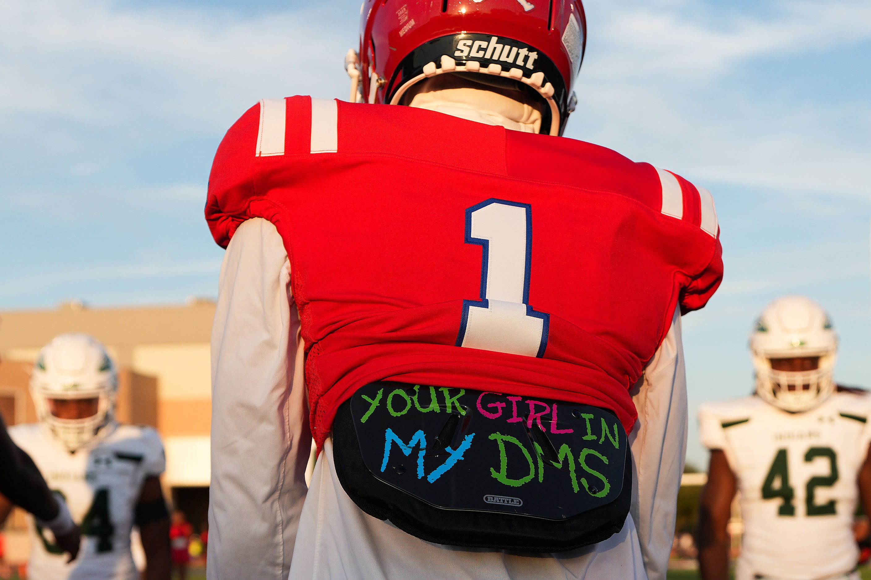 Duncanville wide receiver Dakorien Moore meets other team captains at midfield before a...