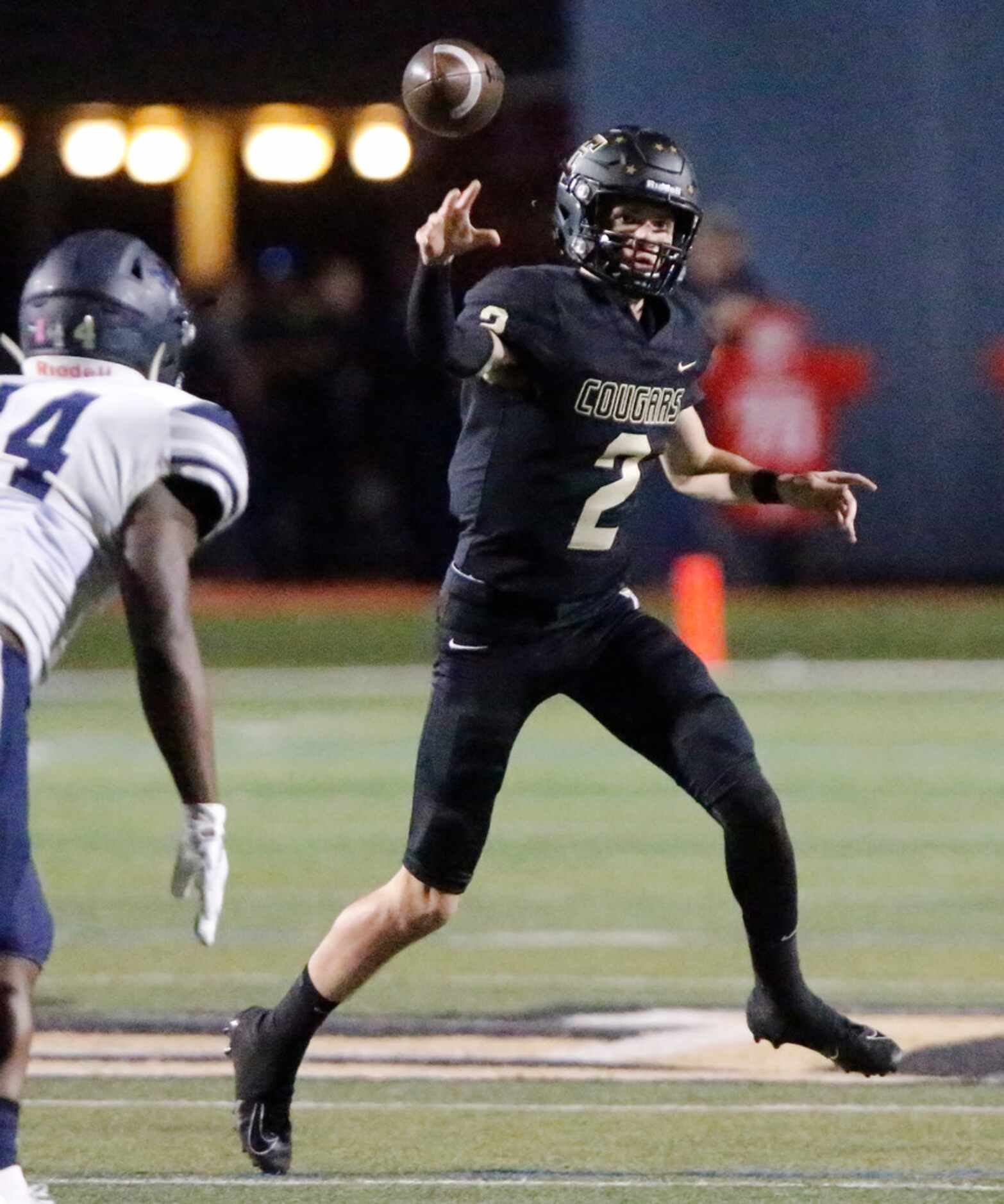 The Colony High School quarterback Kenneth Harrington (2) throws a pass under pressure...