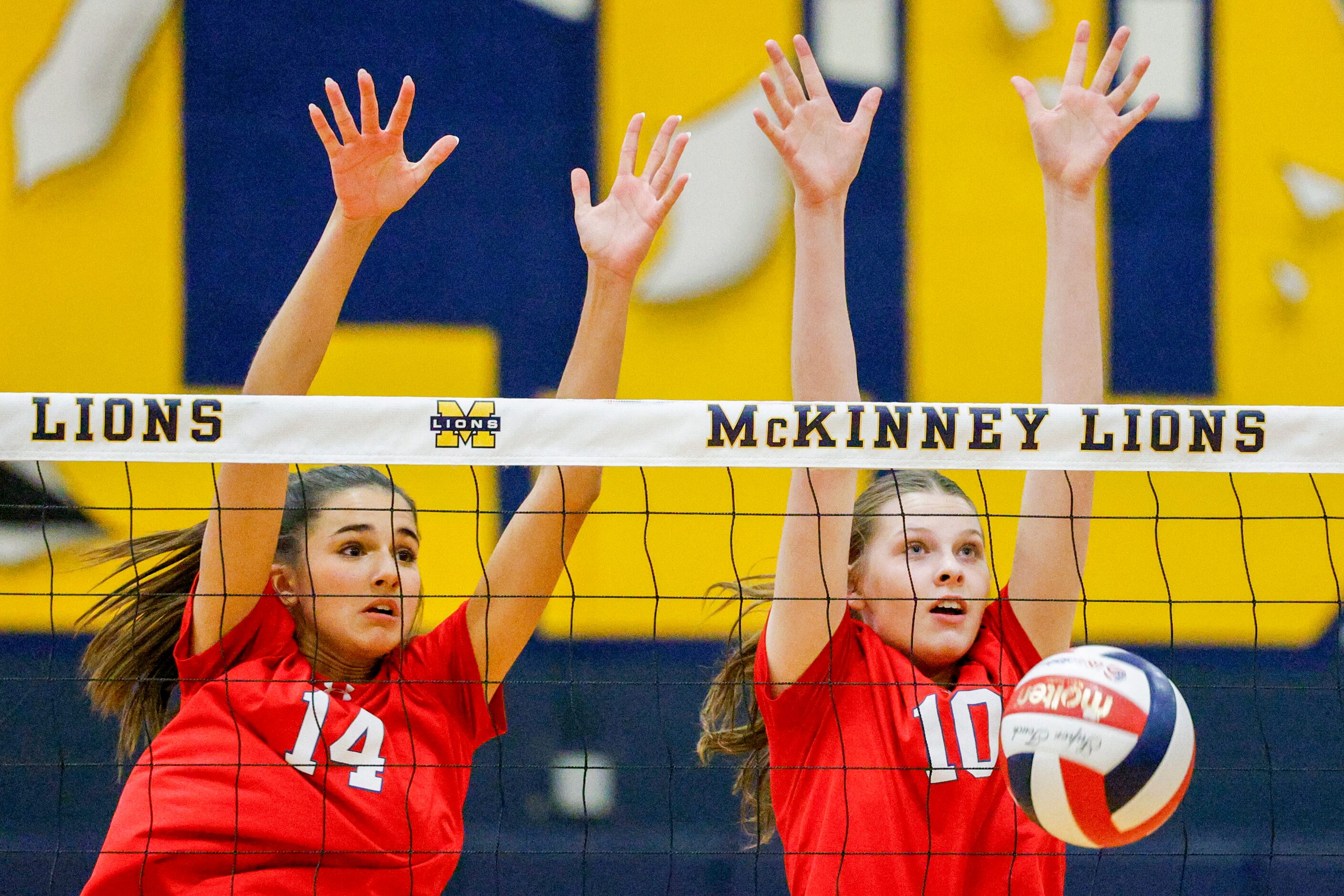 McKinney Boyd’s Keira Bose (14) and Olivia Permenter (10) block a shot during a volleyball...