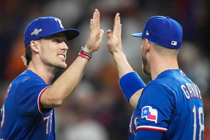 Texas Rangers left fielder Evan Carter (left) celebrates with designated hitter Mitch Garver...