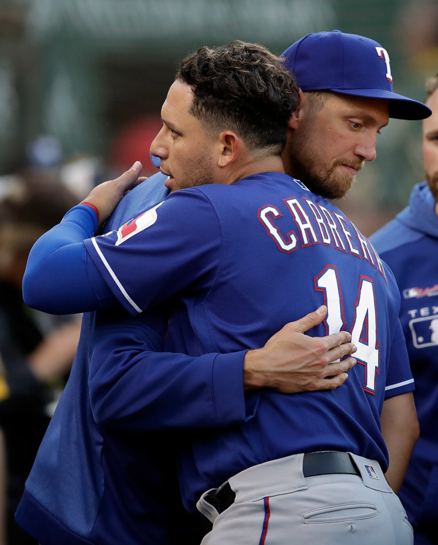 Texas Rangers' Hunter Pence, right, embraces Asdrubal Cabrera (14) prior to the baseball...