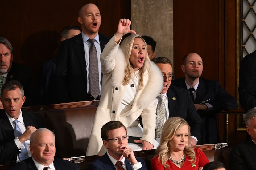 Rep. Marjorie Taylor Greene of Georgia and other Republicans react as President Joe Biden...