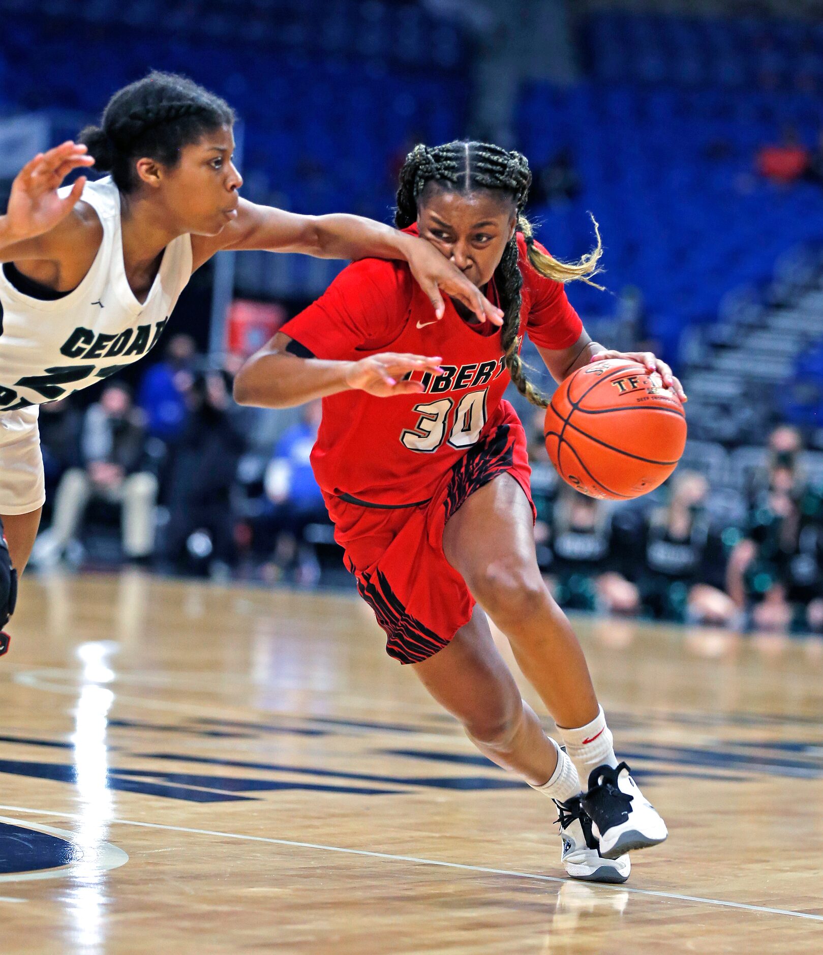 Frisco Liberty Jazzy Owens-Barnett #30 drives on Cedar Park Alisa Knight #23. Frisco Liberty...