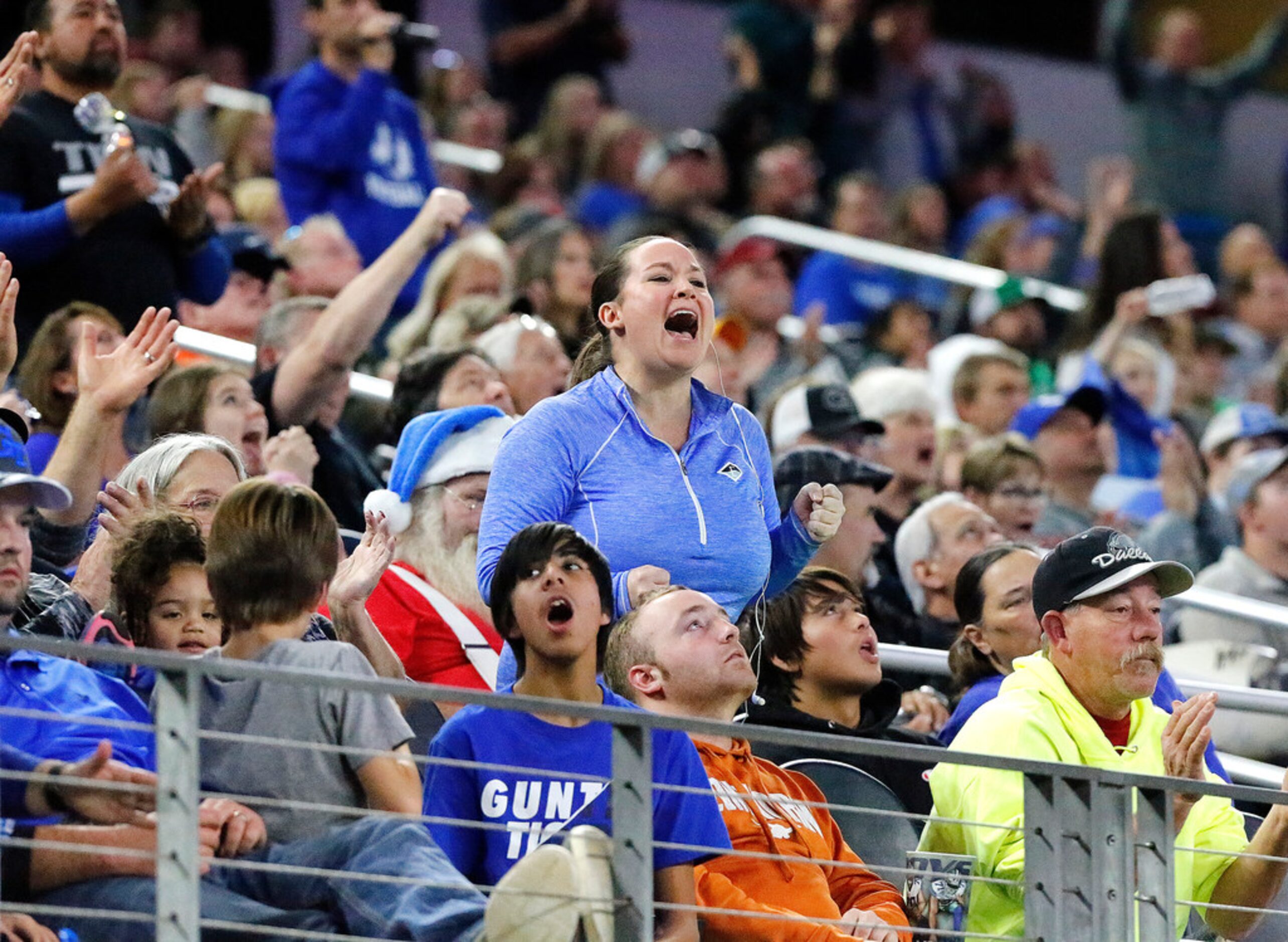 Gunter High School fans cheer a defensive stand near the end of the game as Omaha Pewitt...