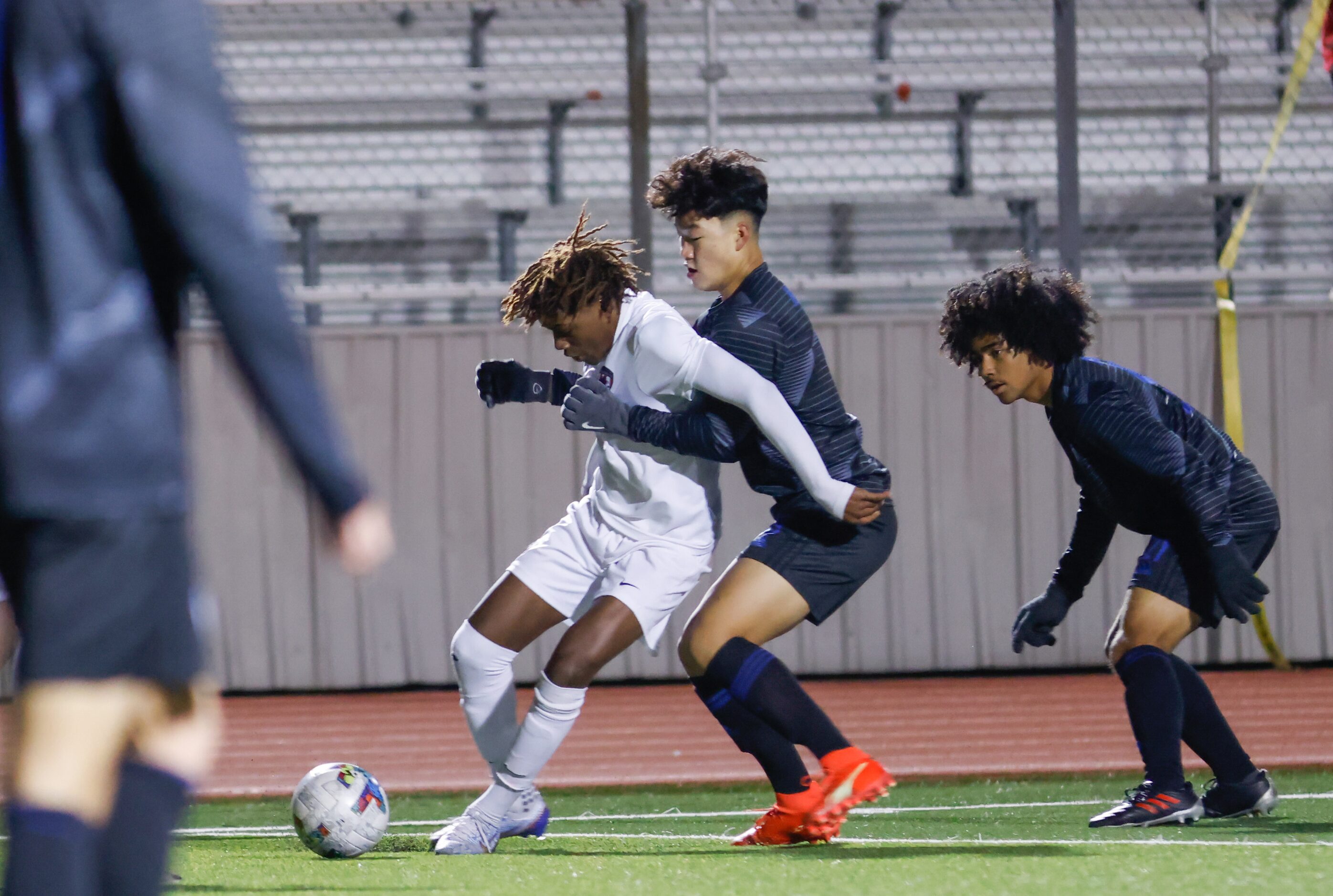 Flower Mound Marcus’ Aaron Pondeca (10) is pressured from behind by Hebron’s Adrian Ho (9)...