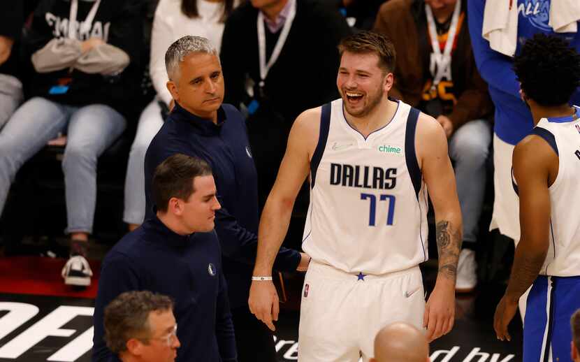 Dallas Mavericks guard Luka Doncic (77) smiles towards referee David Guthrie (16) after a...