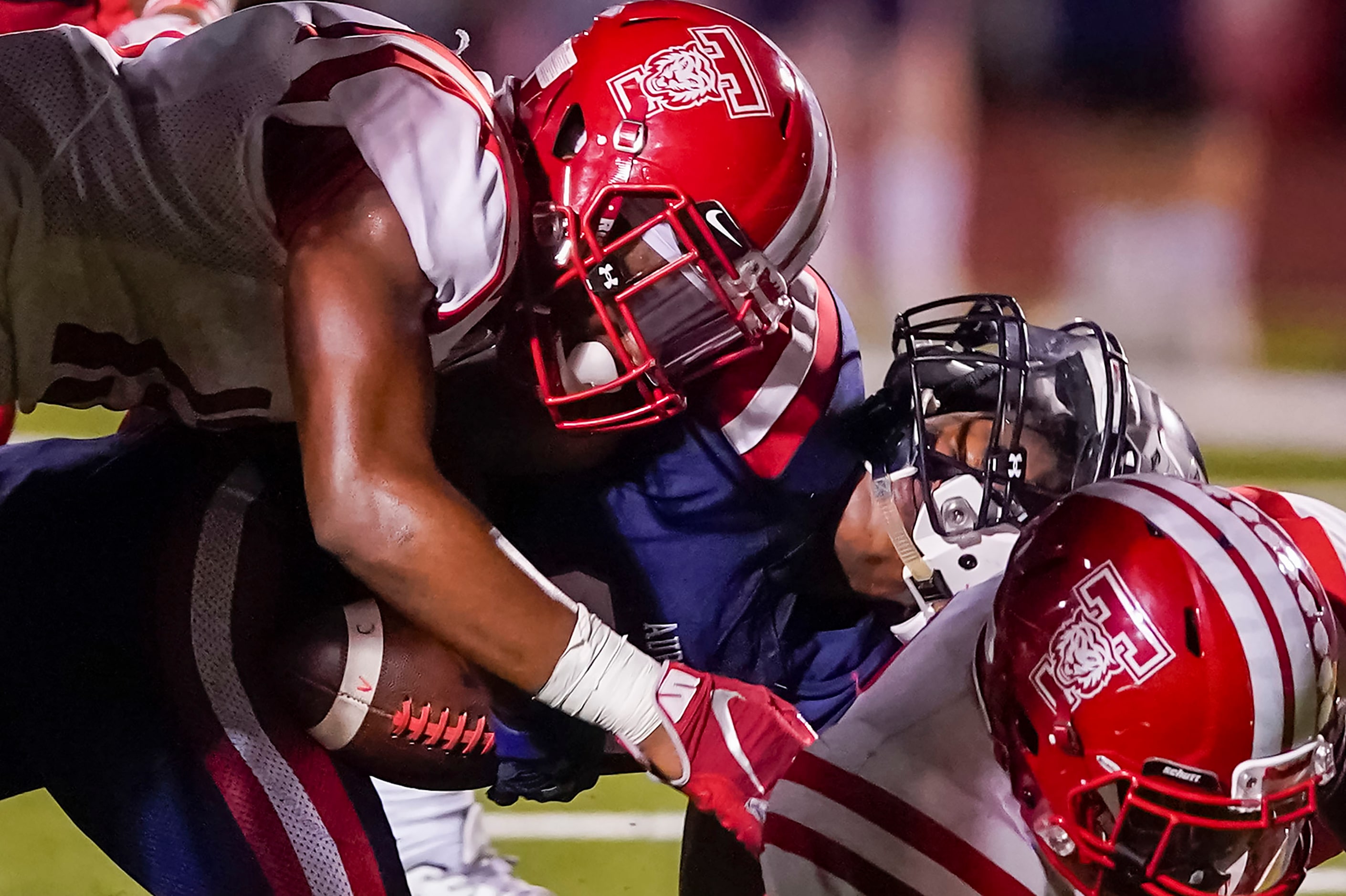 Aubrey running back  Braylon Colgrove (21) has his helmet turned sideways as he is brought...