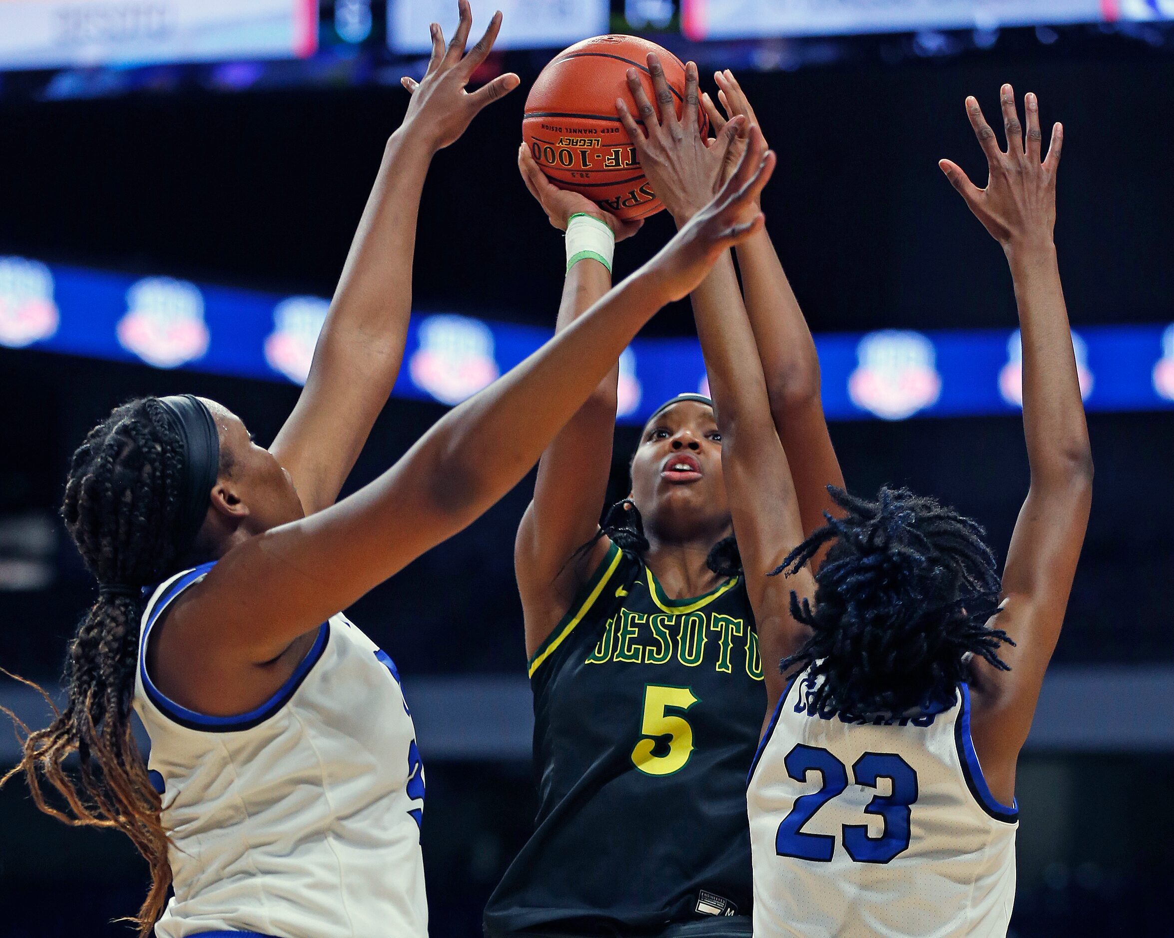 DeSoto Sa’Myah Smith #5 shoots over Cypress Creek defenders. DeSoto vs. Cypress Creek girls...