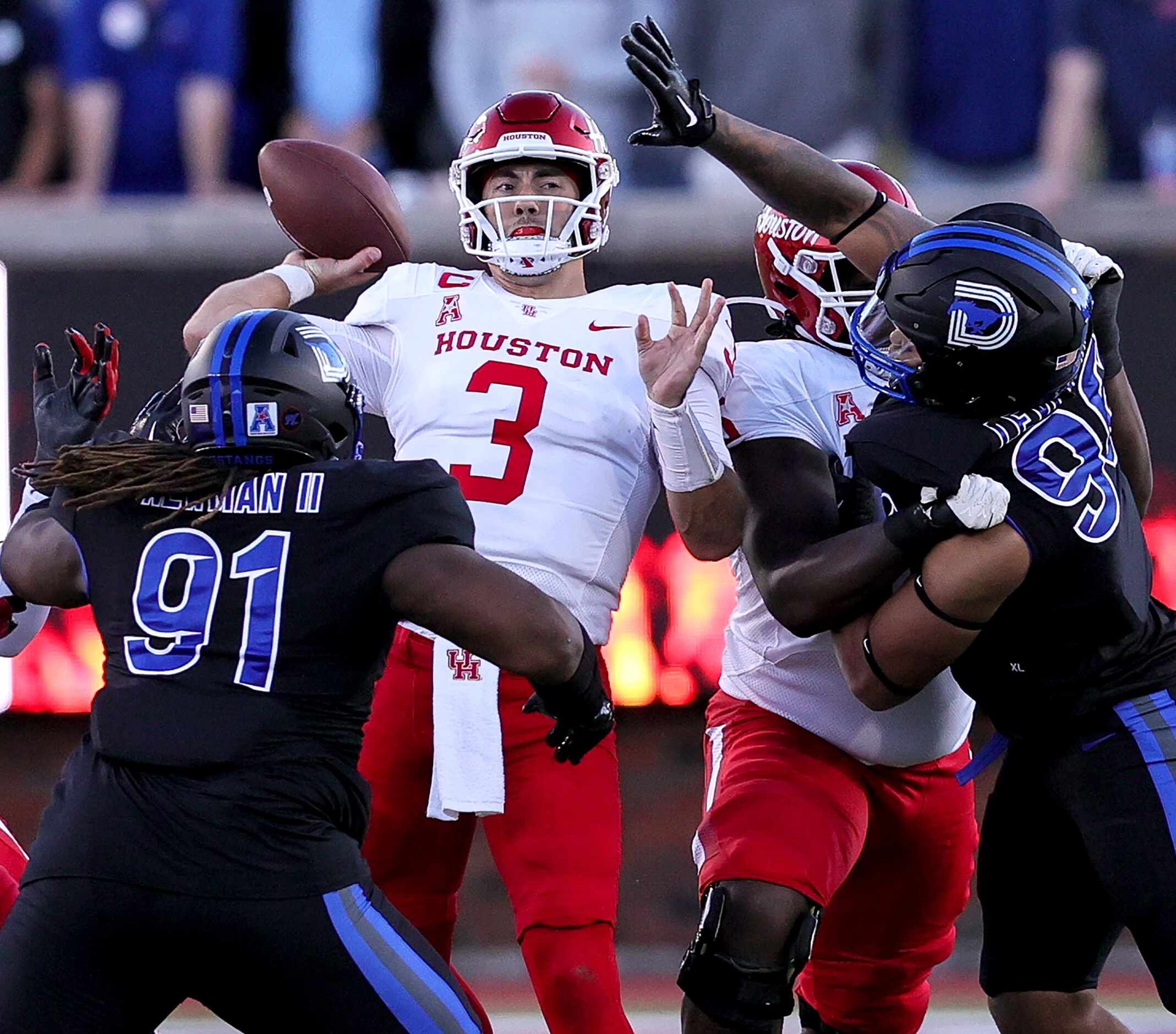 Houston quarterback Clayton Tune (3) gets some pressure from SMU defensive tackle Terrance...