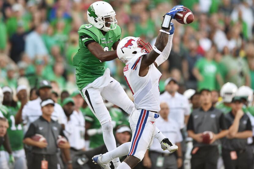 Southern Methodist senior defensive back Horace Richardson (9) intercepts a pass meant for...
