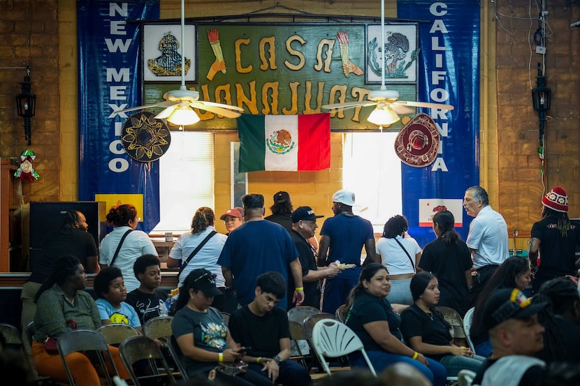 Un grupo de personas se forma para comer tacos durante un torneo de boxeo como parte de las...