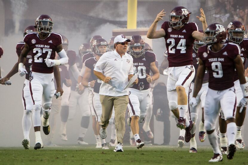 Texas A&M Aggies head coach Jimbo Fisher breaks onto the field with the team prior to a...