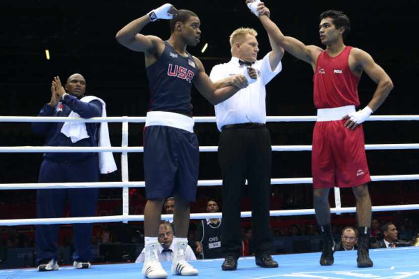 USA's Errol Spence hand is raised although the announcer mentioned the red corner's India's...