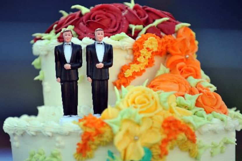 A wedding cake with statuettes of two men was displayed during a demonstration in West...