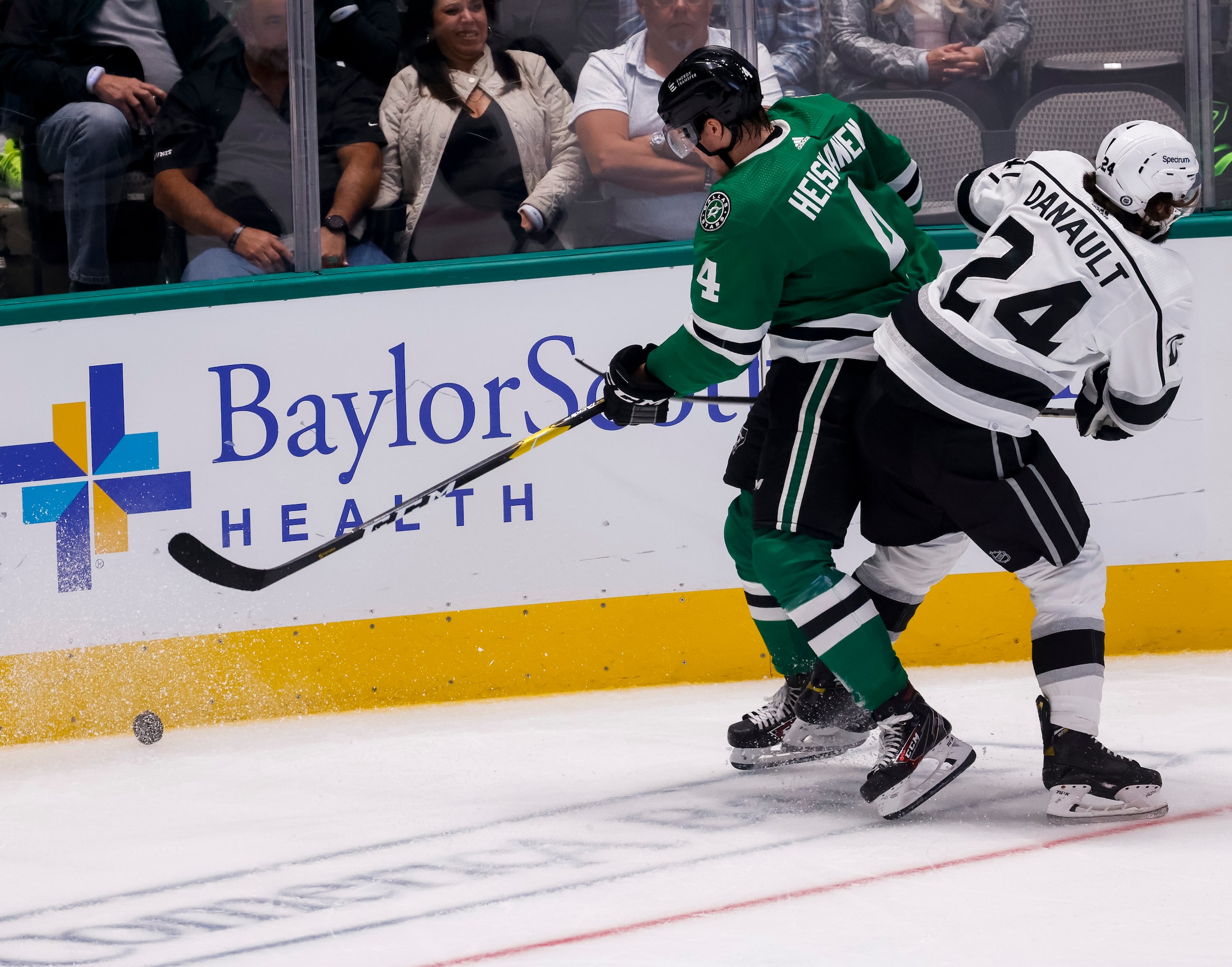 Dallas Stars defenseman Miro Heiskanen (4) hits the puck from Los Angeles Kings left wing...