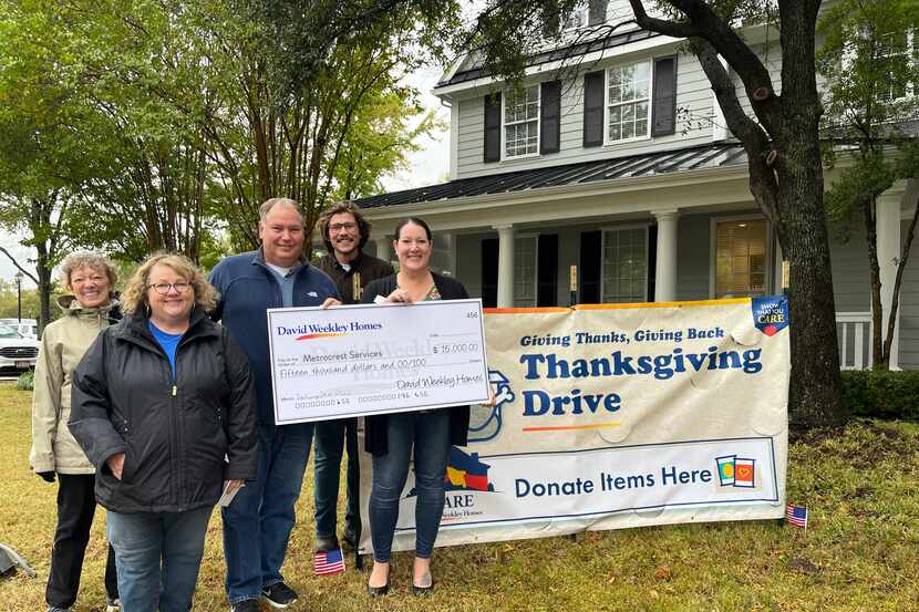 David Weekley Homes team members in Dallas/Ft. Worth presented a check for $15,000 to...