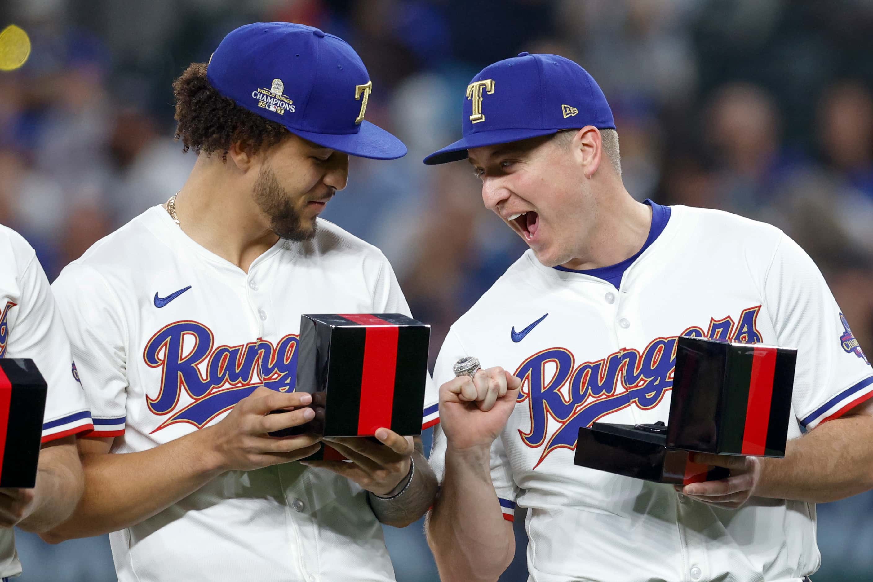 Texas Rangers relief pitcher Josh Sborz (right) screams as he shows off his World Series...