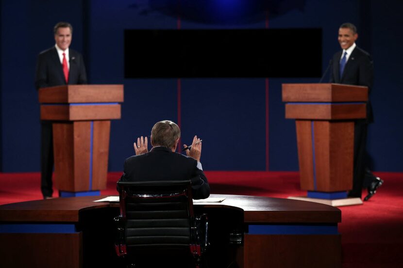 Jim Lehrer (center) spoke to presidential candidates Mitt Romney and Barack Obama during a...