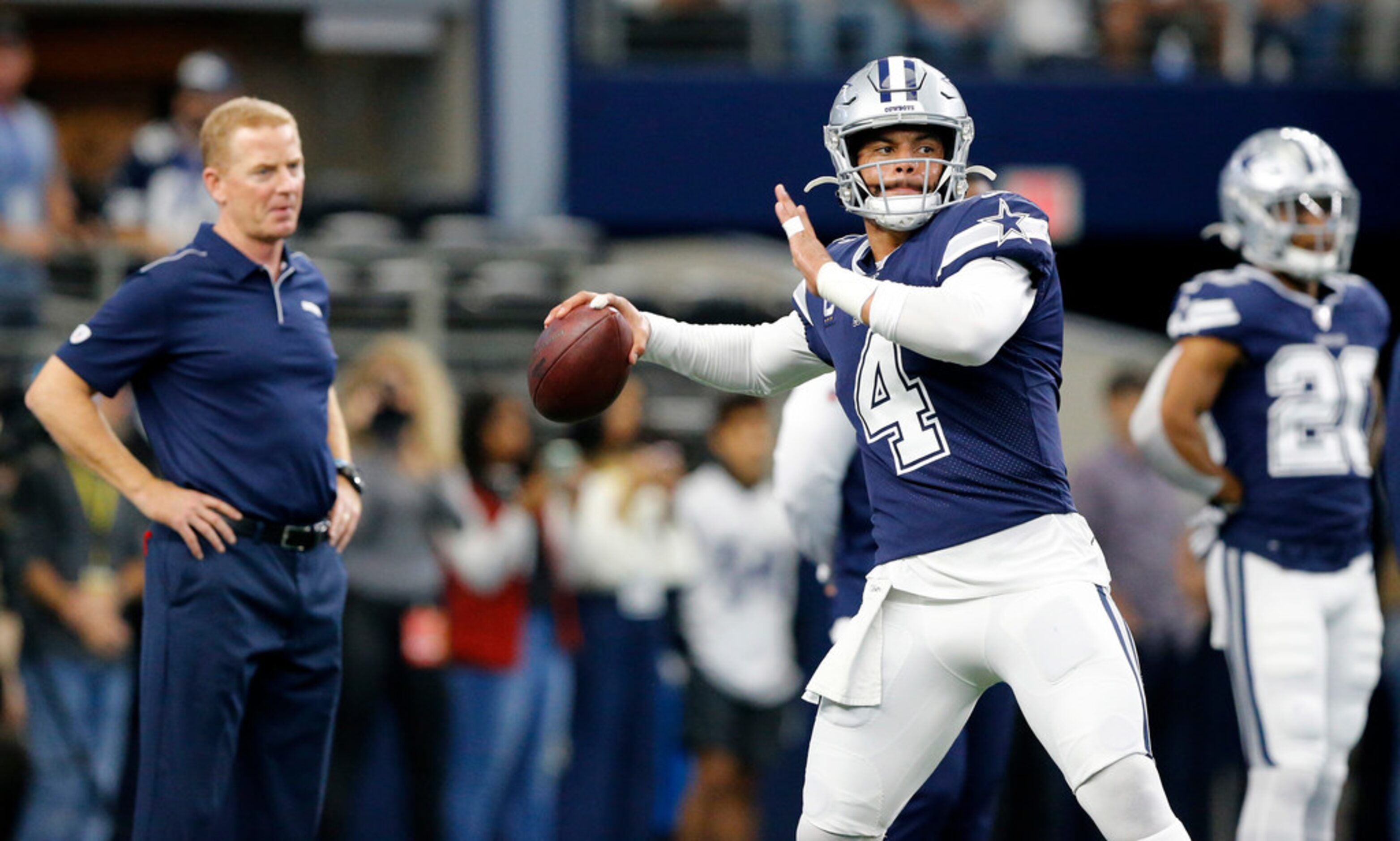 Head coach Jason Garrett (left) watches Dallas Cowboys quarterback Dak Prescott (4) throw...