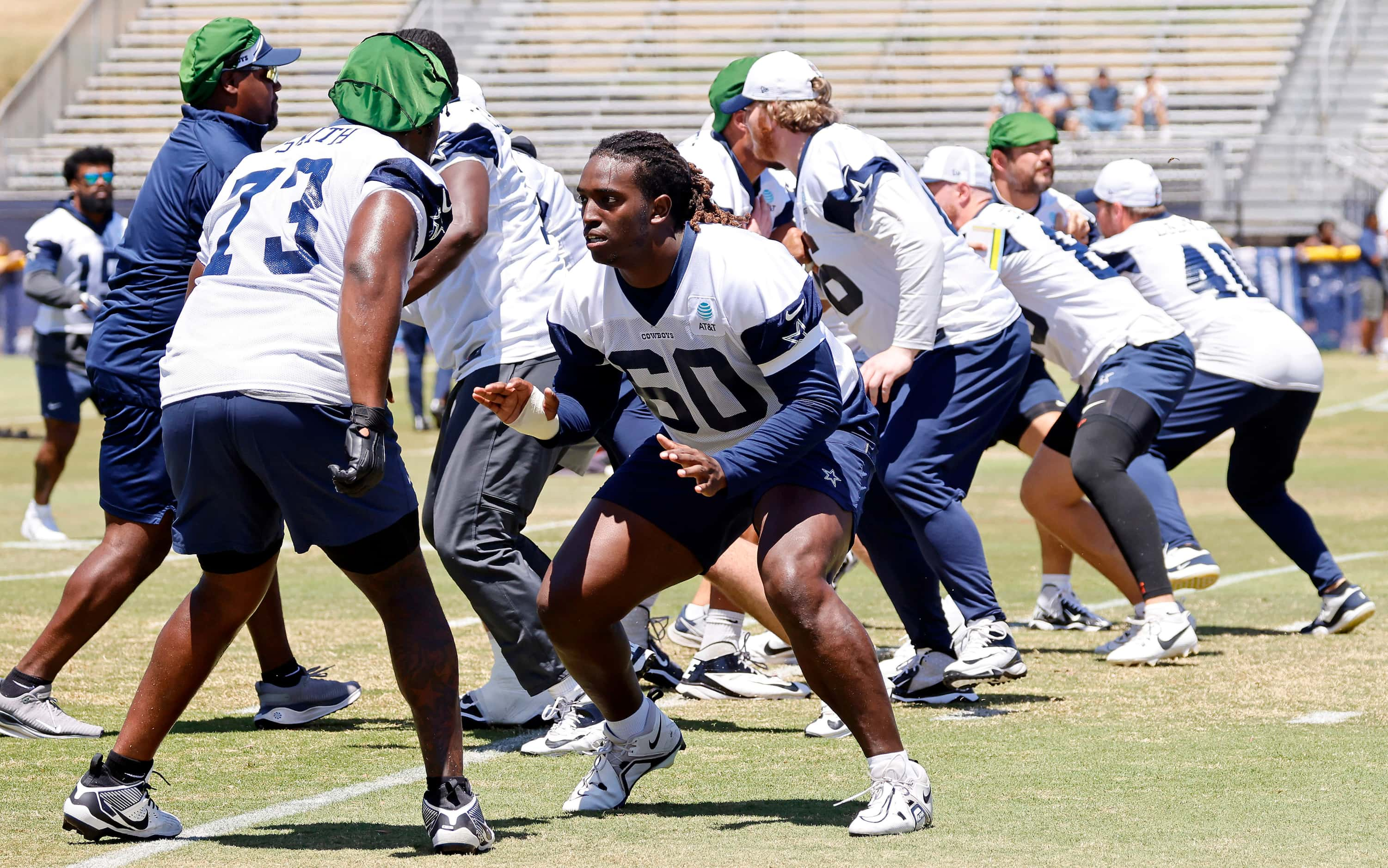 Dallas Cowboys tackle Tyler Guyton (60) prepares to block offensive tackle Tyler Smith (73)...