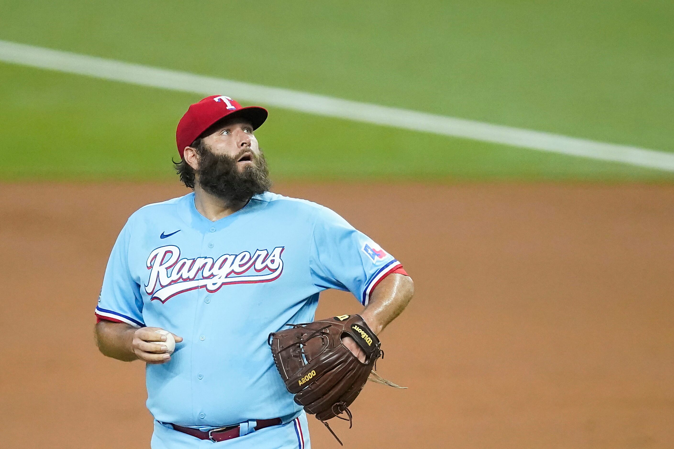 Texas Rangers pitcher Lance Lynn reacts after giving up a single to Los Angeles Angels...