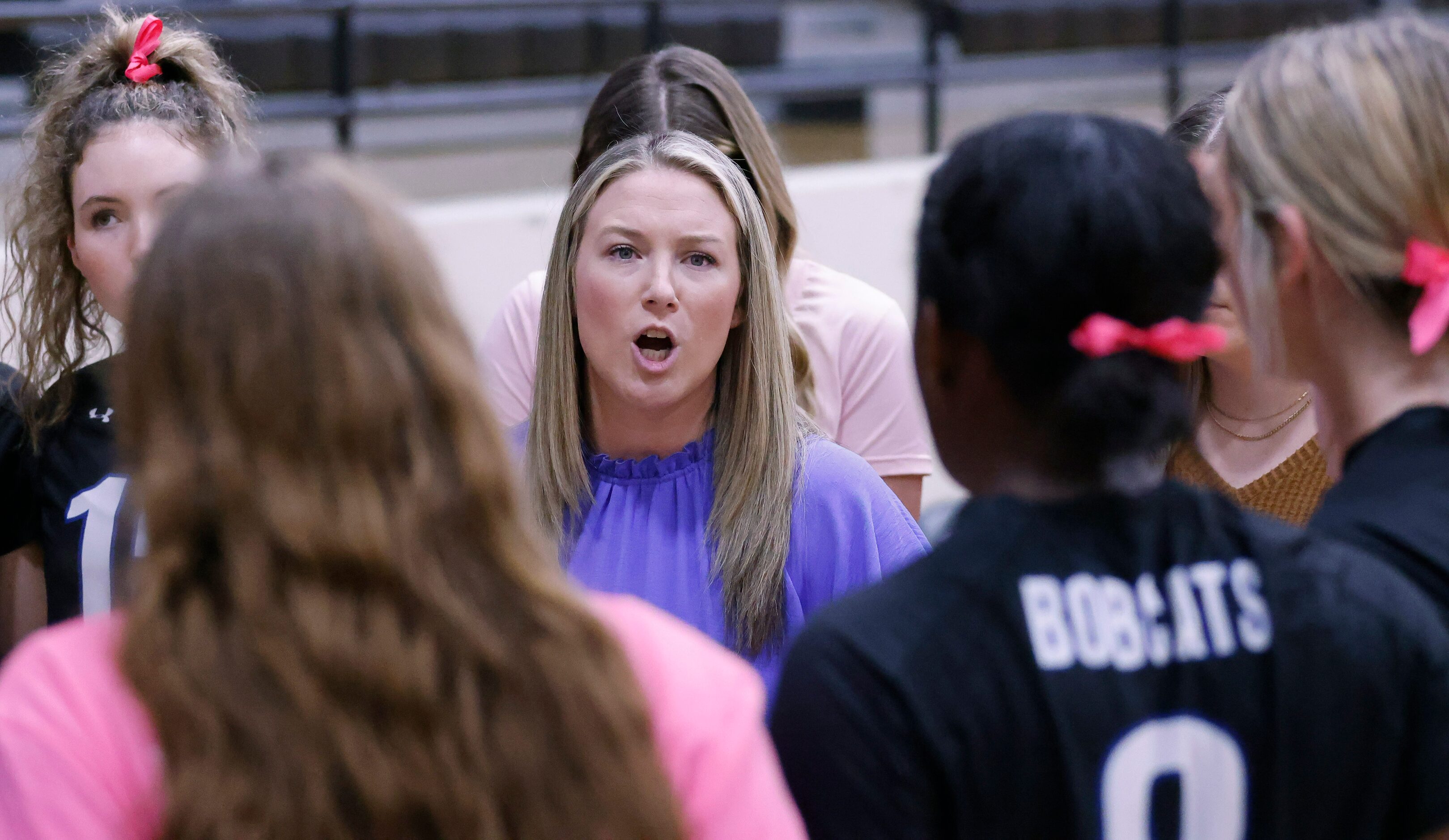 Trophy Club Byron Nelson Head Coach Brianne Groth gathers her players between games against...