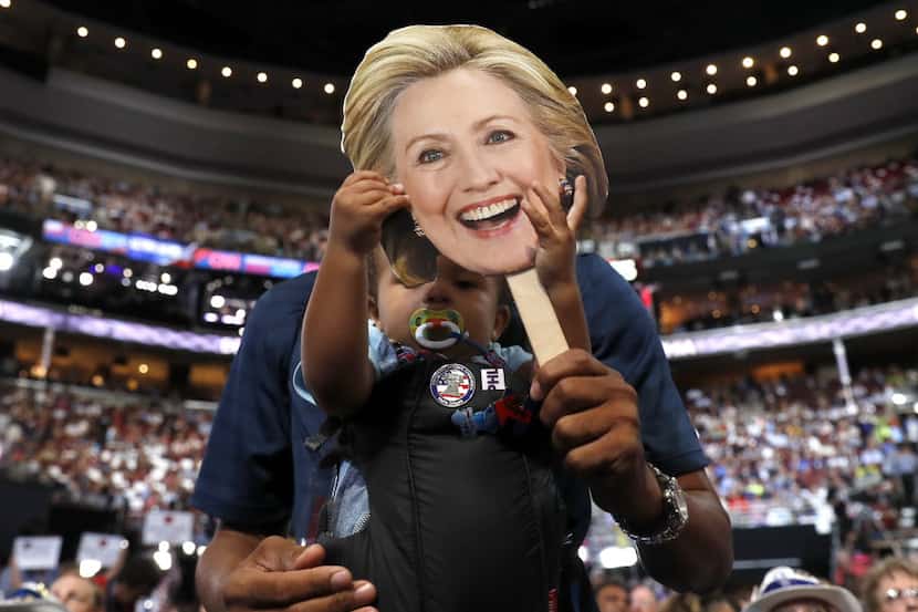 16-month Ethan Jennings grabs a cardboard cutout of the face of Democratic Presidential...
