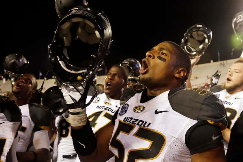 FILE - In this Sept. 21, 2013, file photo, Missouri's Michael Sam (52) sings the school song...