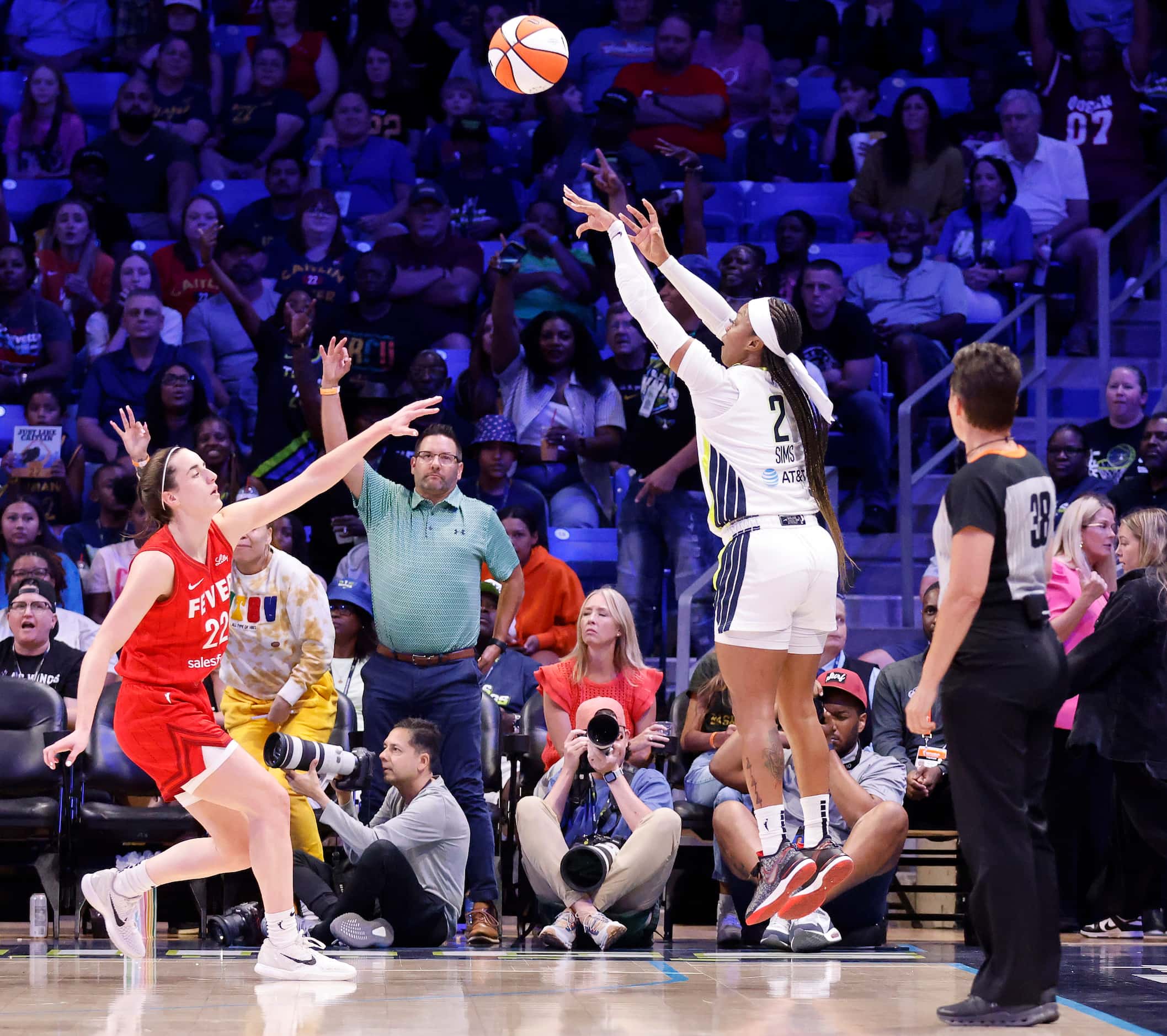 Dallas Wings guard Odyssey Sims (2) puts up a three-pointer over Indiana Fever guard Caitlin...