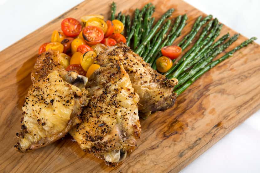 Oven baked chicken thighs with roasted asparagus and cherry tomatoes 