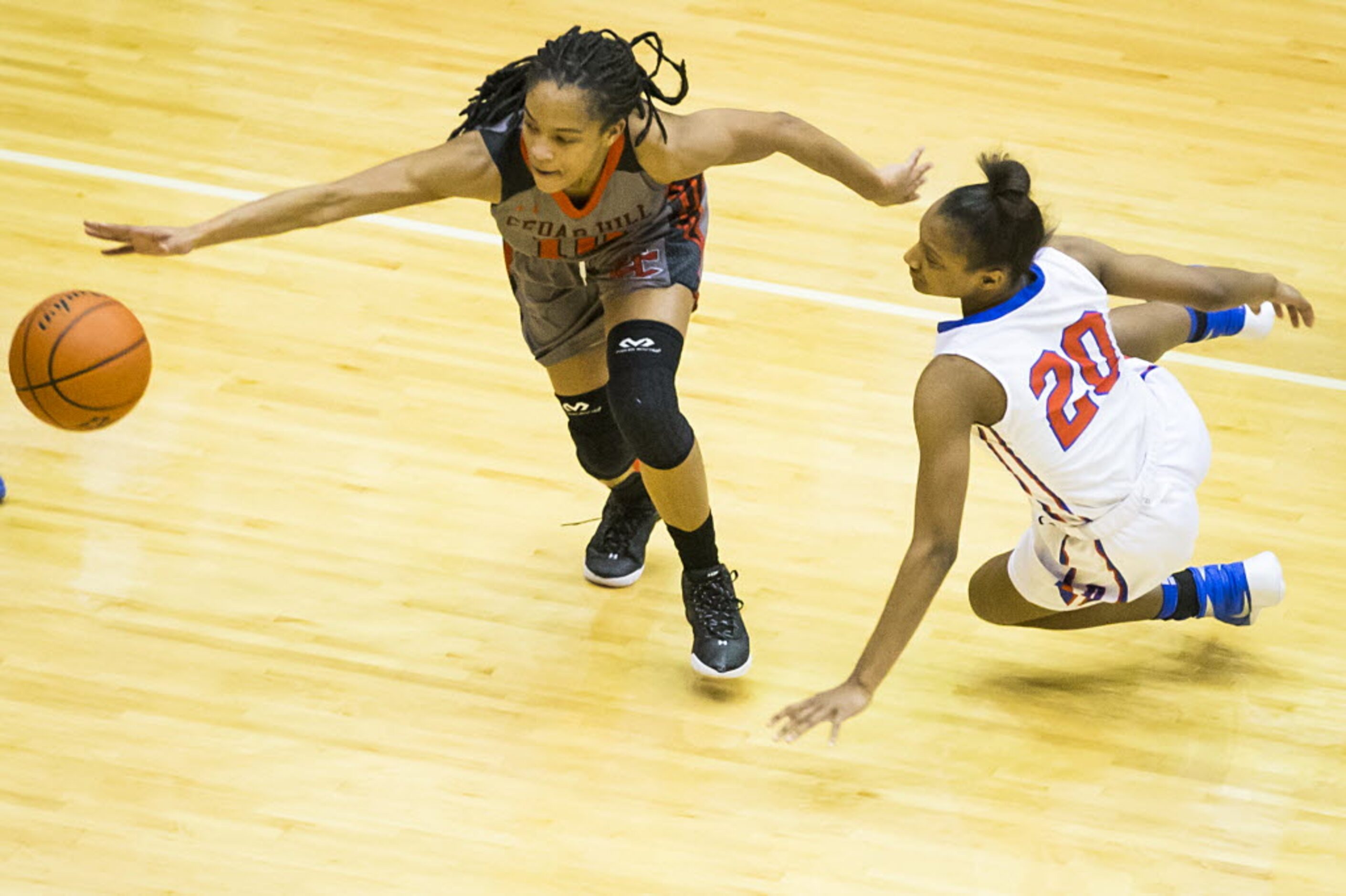 Cedar Hill guard Victoria Jackson (10) and Duncanville guard Aniya Thomas (20) fight for a...