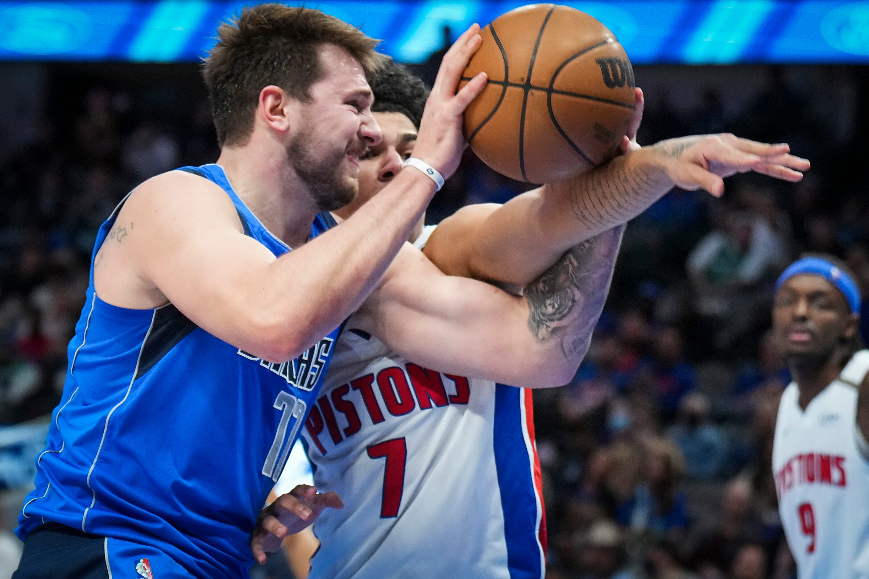 Dallas Mavericks guard Luka Doncic (77) is fouled by Detroit Pistons guard Killian Hayes (7)...