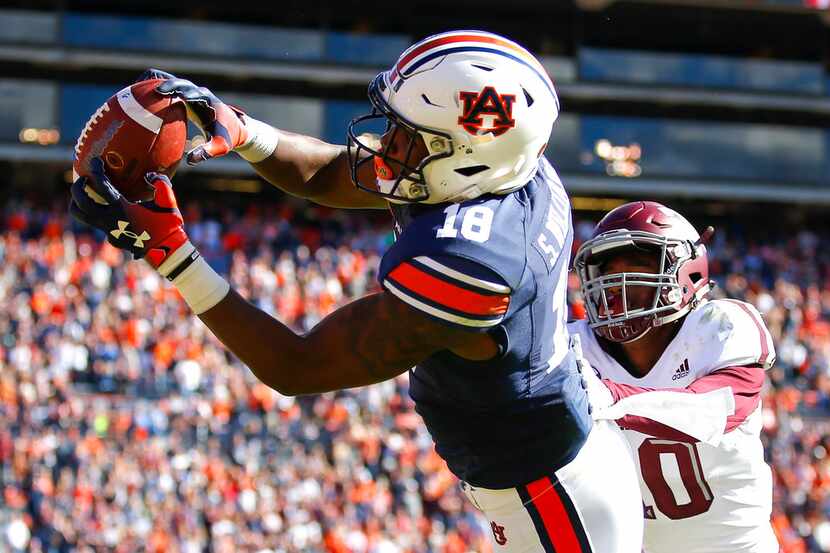 Auburn wide receiver Seth Williams (18) reaches a touchdown reception as Texas A&M defensive...