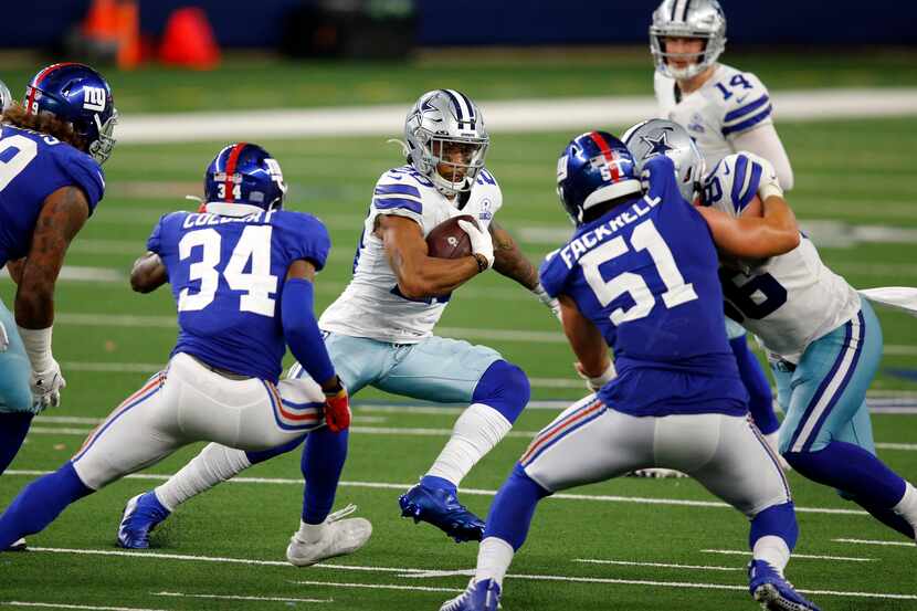 Dallas Cowboys running back Tony Pollard (20) cutback against the New York Giants defense as...