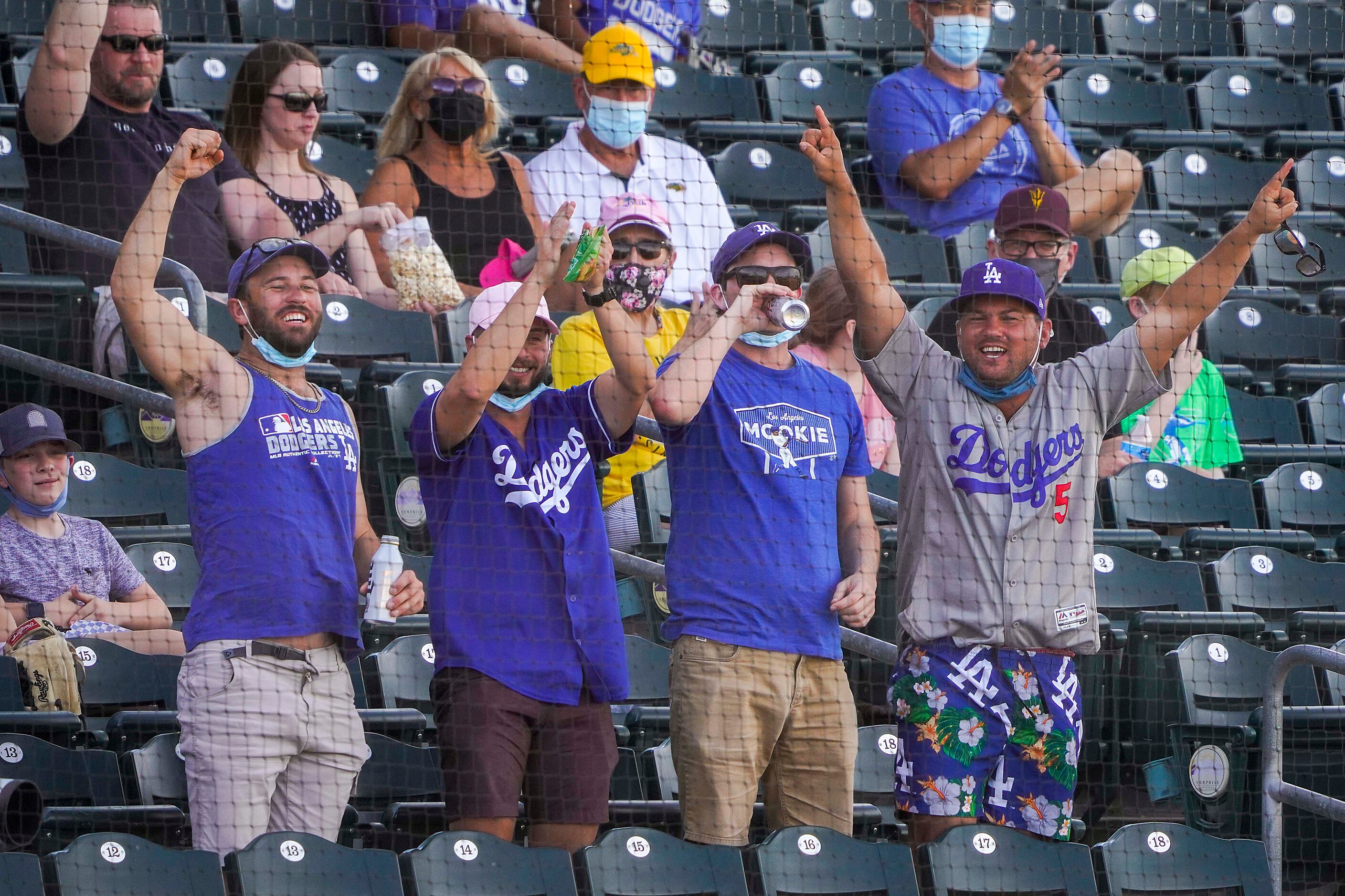 Los Angeles Dodgers fans cheer a home run by Dodgers center fielder DJ Peters off of Texas...