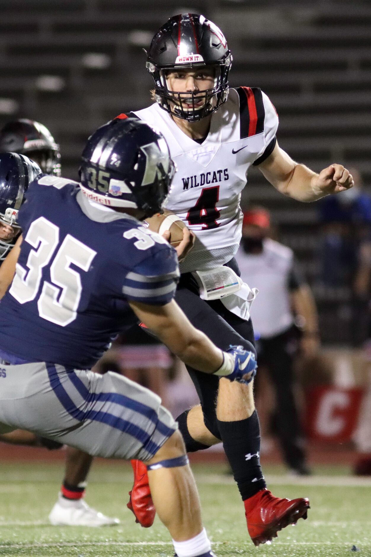 Lake Highlands quarterback Caden Dotson (4) runs the ball against Irving Nimitz linebacker...