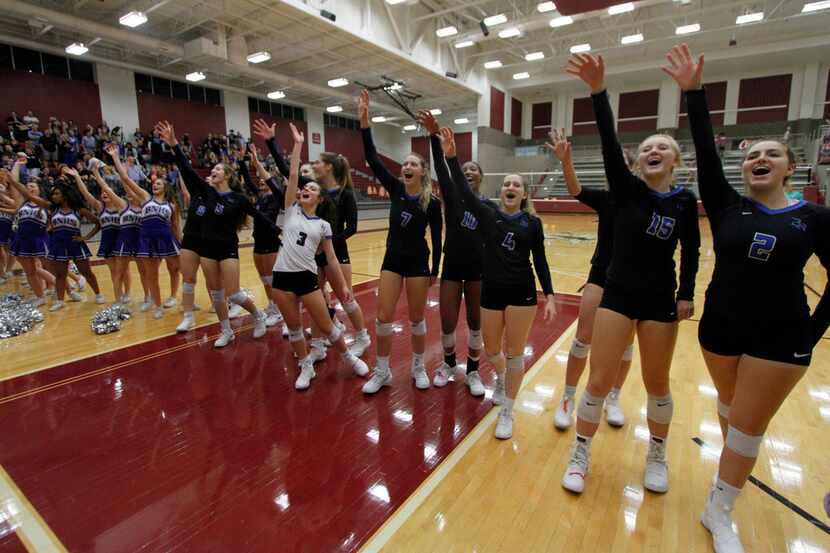 Members of Byron Nelson volleyball team celebrates after a playoff win over Flower Mound...