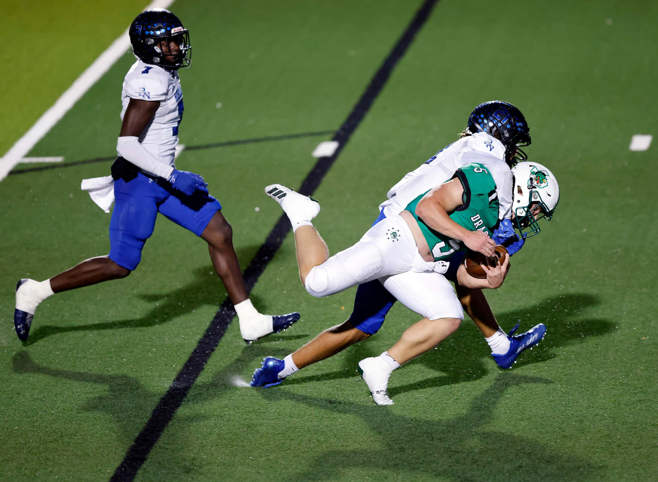 Southlake Carroll running back James Lehman (5) is taken down by Byron Nelson’s Leo Almanza...