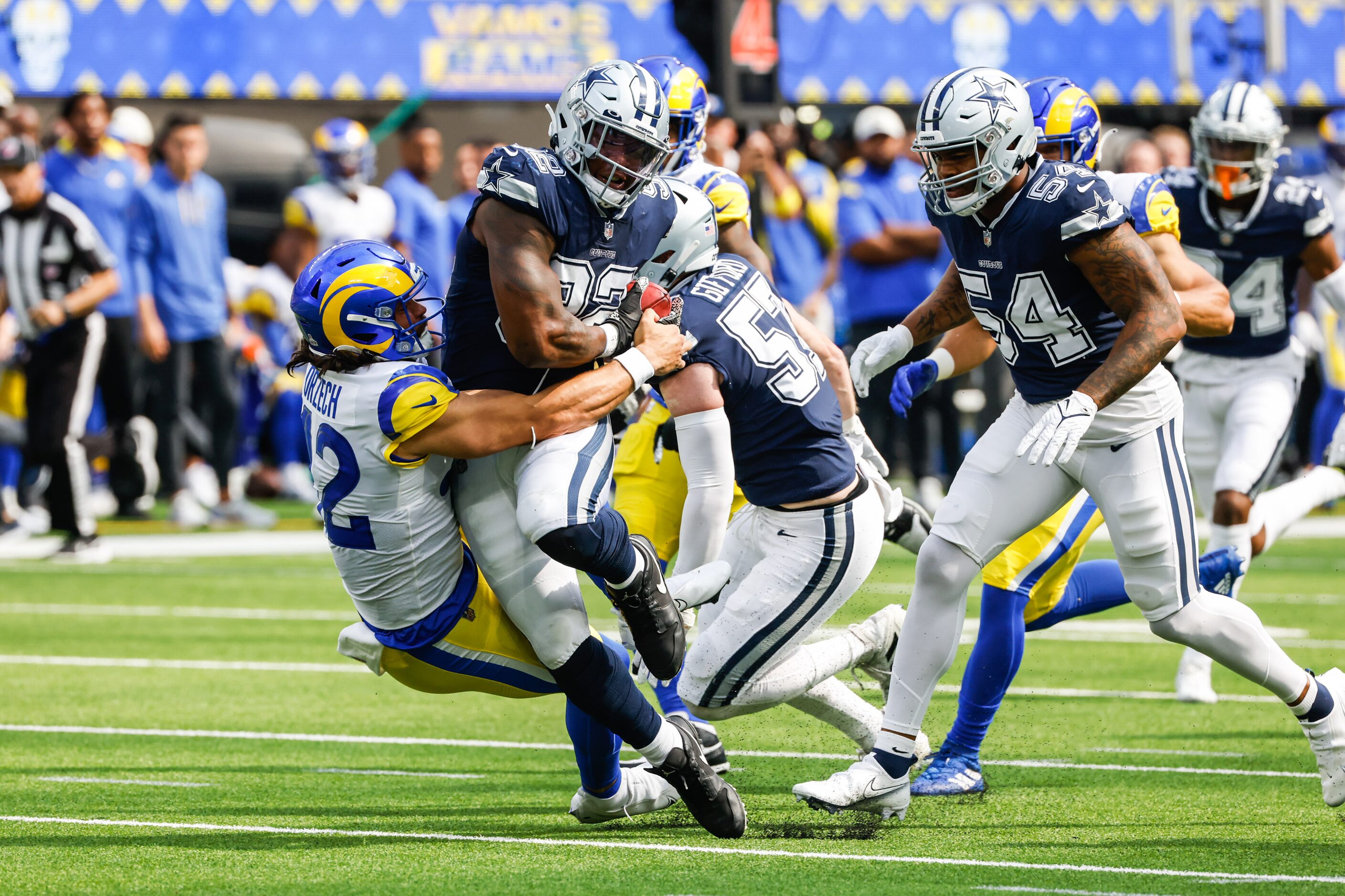 Dallas Cowboys defensive end Dorance Armstrong (92) scoops up the ball past Los Angeles Rams...