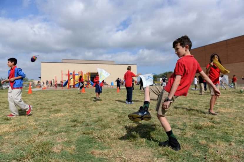 
Fourth-grader Jake Hrbacek plays hacky sack during the Chinese Dragon Boat Festival at R.E....