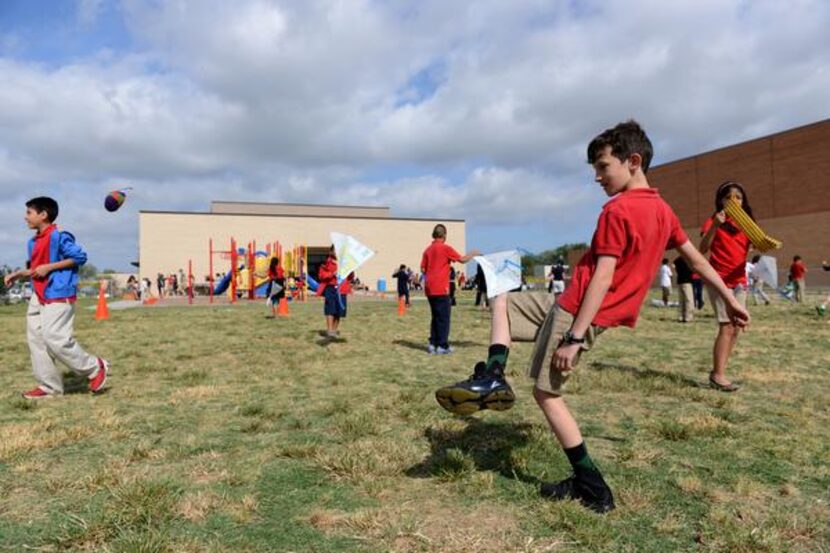 
Fourth-grader Jake Hrbacek plays hacky sack during the Chinese Dragon Boat Festival at R.E....