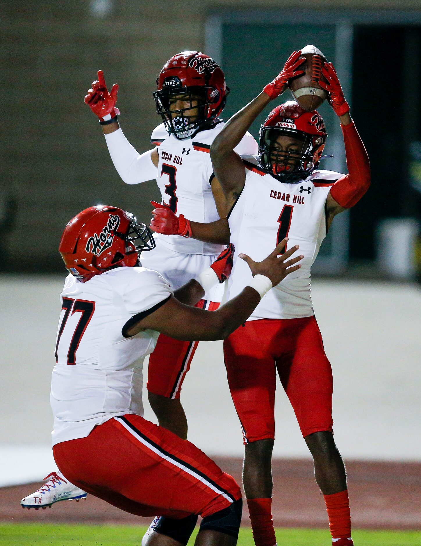 Cedar Hill senior wide receiver Anthony Thomas IV (1) is congratulated by senior offensive...