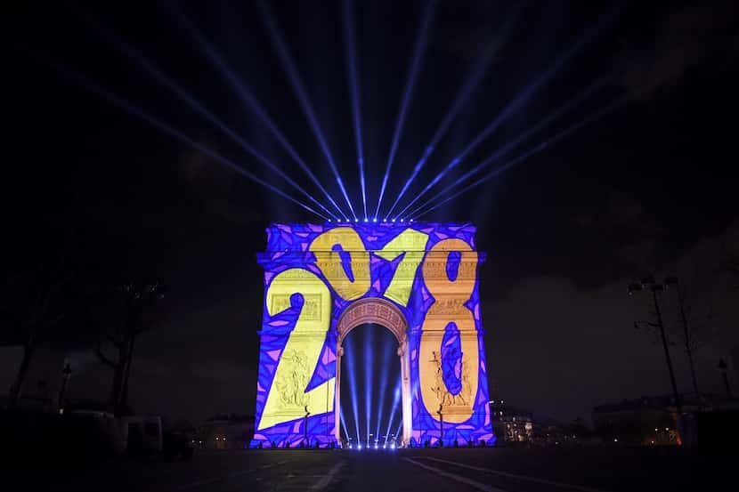 Images are projected on the Arc de Triomphe monument during a laser and 3D video mapping...