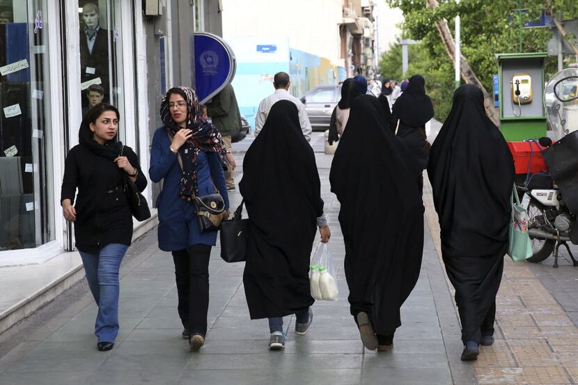 Iranian women make their way along a sidewalk in downtown Tehran, Iran, Tuesday, April 26,...