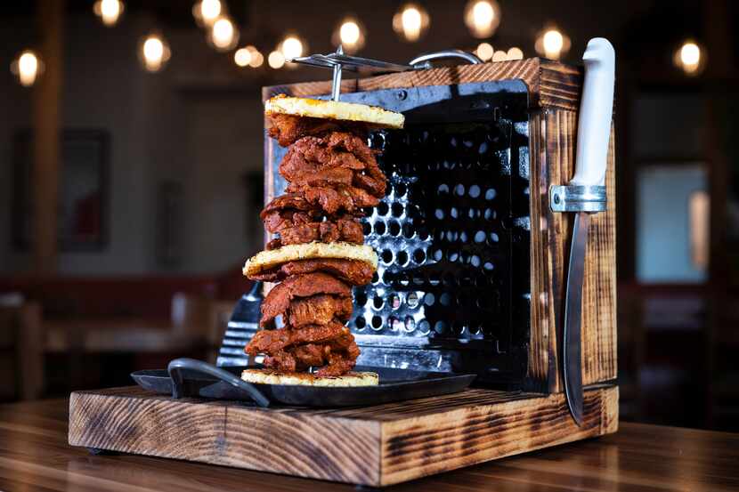 Trompo al Pastor is a mini rotisserie carved tableside at El Patio restaurant in The Realm...