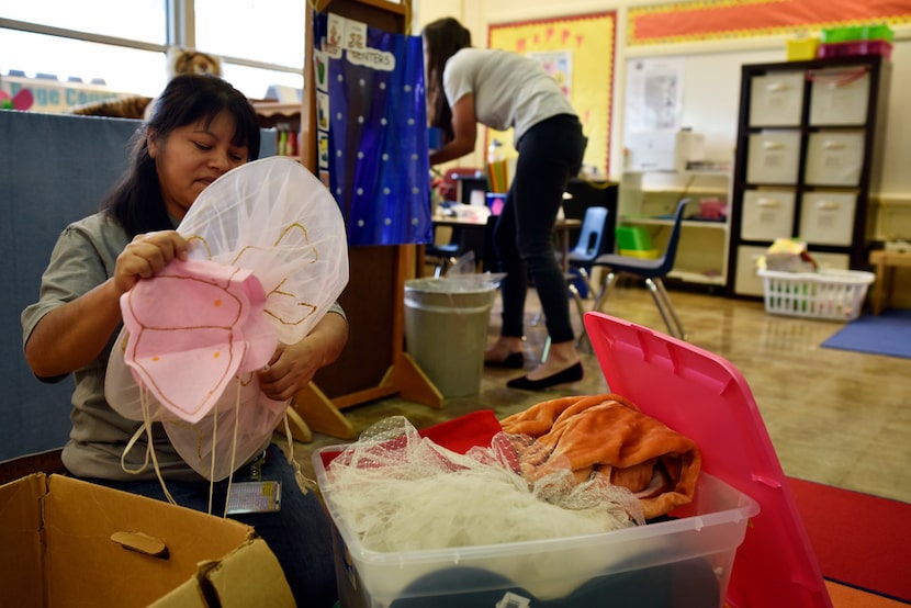 Teacher assistants Alicia Leon (left) and Lyndsey Patman prepare a shared classroom by...