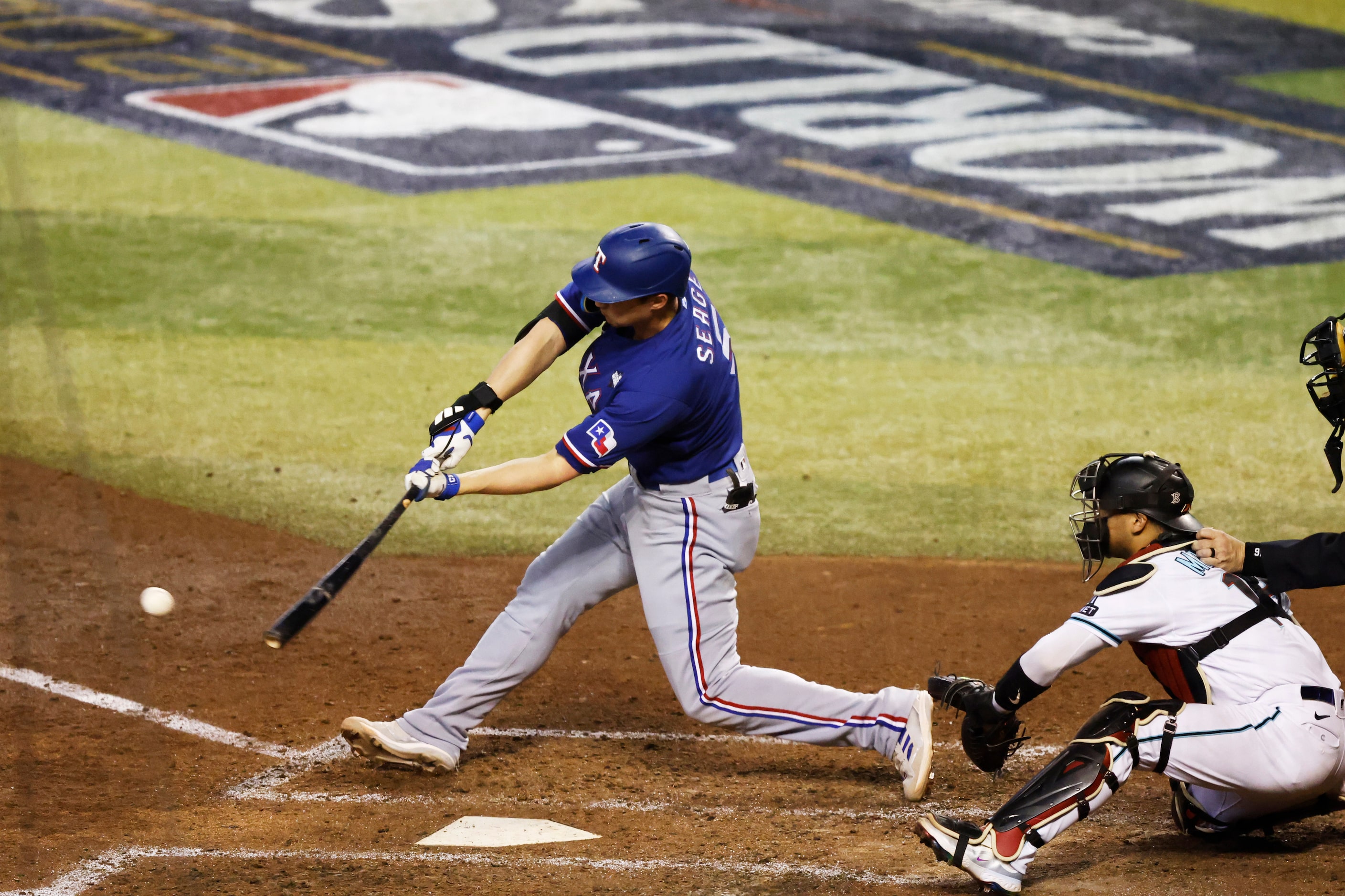 Texas Rangers’ Corey Seager connects for a single during the seventh inning in Game 5 of the...