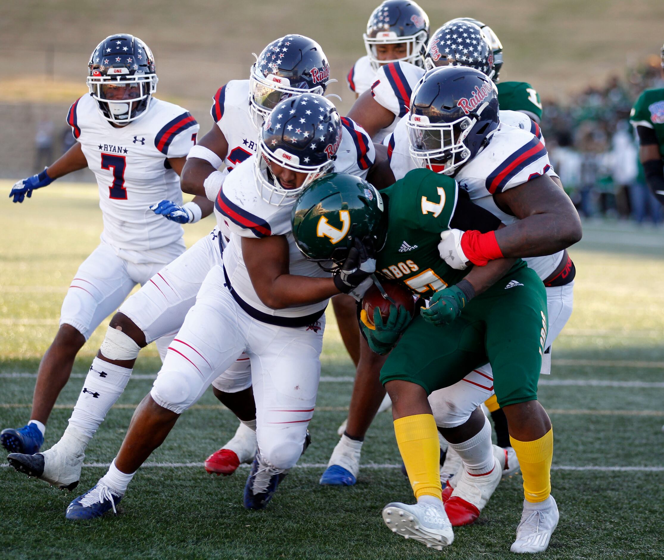 Longview RB Markevion Haynes (17) is gang tackled by Denton Ryan defenders during the final...