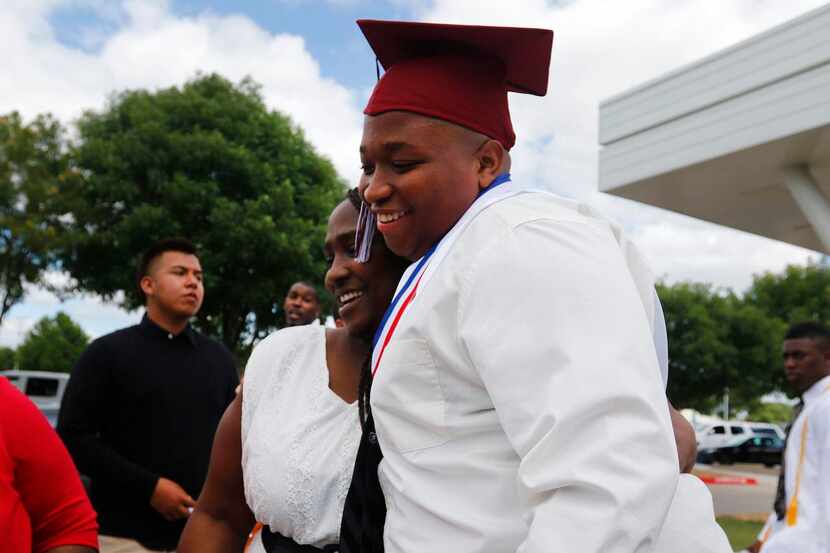 
Shatonya King hugs Christopher Robertson Jr. after the Mesquite High School graduation...